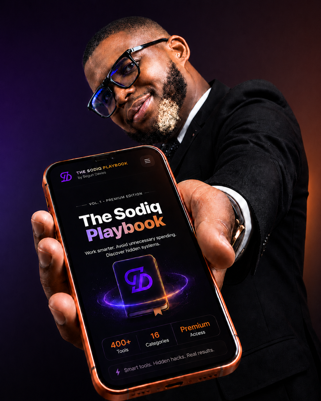 Segun Davies holding The Sodiq Playbook on phone